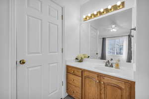 Bathroom with vanity and ceiling fan
