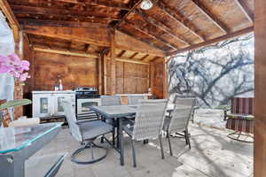 View of patio / terrace with washer / clothes dryer and outdoor dining area