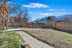View of yard featuring a fenced backyard and a mountain view