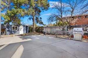 View of patio featuring grilling area, an outdoor structure, and a fenced backyard