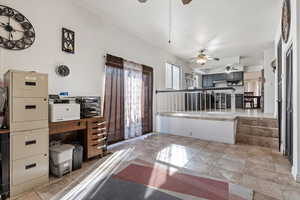 Interior space featuring tile patterned floors, baseboards, and a ceiling fan