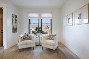 Living area with wood finished floors and baseboards