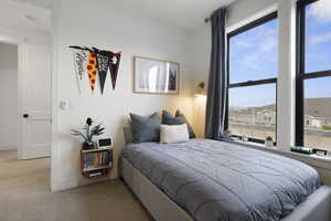 Bedroom featuring baseboards and carpet floors