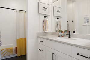 Bathroom featuring vanity and curtained shower