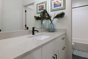 Full bathroom featuring toilet and vanity