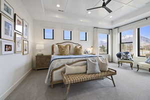 Bedroom with baseboards, a raised ceiling, wood ceiling, and carpet flooring