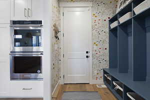 Mudroom featuring wallpapered walls, visible vents, and light wood finished floors