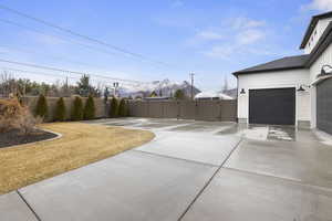 Exterior space featuring a garage, fence, driveway, and a gate