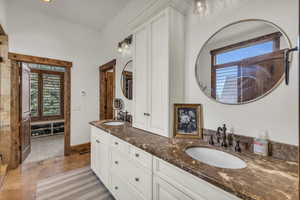 Full bathroom with a sink, baseboards, and double vanity