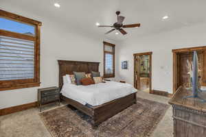 Bedroom featuring visible vents, baseboards, recessed lighting, ensuite bathroom, and carpet flooring