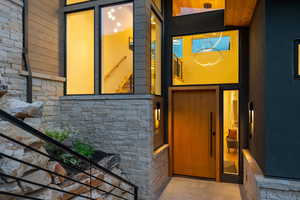 Doorway to property with stone siding