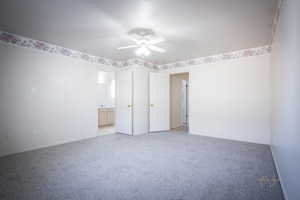 Spare room featuring light carpet, baseboards, and ceiling fan