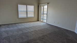 Carpeted empty room with baseboards