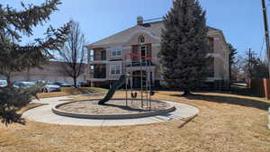 Community playground with a yard and fence