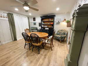 Dining space featuring light wood-style flooring, crown molding, and ceiling fan