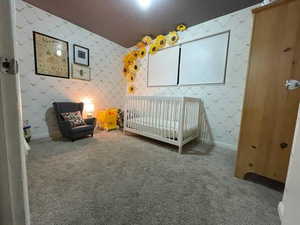 Unfurnished bedroom featuring wallpapered walls, carpet, and baseboards