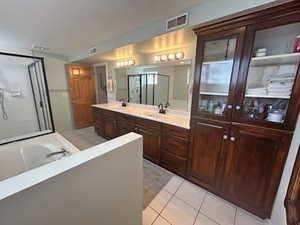 Full bathroom with visible vents, a garden tub, a shower stall, tile patterned flooring, and vanity