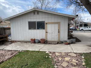 View of outbuilding with an outdoor structure and fence