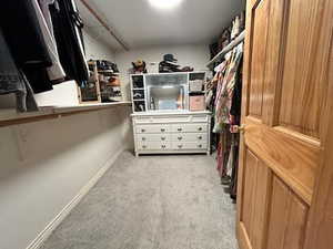 Walk in closet with light carpet