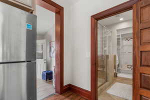 Kitchen leads to the large laundry room to the left, the bathroom straight ahead, and the lower level to the right.