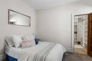 Newly carpeted bedroom with an ensuite bathroom and walk-in closet.