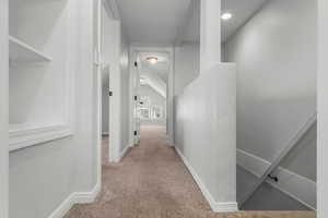 Upstairs hallway leading to two light-filled rooms.