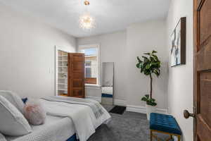 Newly carpeted bedroom with an ensuite bathroom and walk-in closet and a window for natural light.