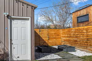 Oversize garage with raised garden beds and a back gate that leads to Westminster Park.