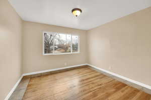 Bedroom with light wood-style floors and baseboards