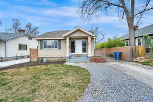 Bungalow with fence, a shingled roof, a front lawn, and a gate