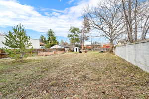 View of yard featuring an outbuilding and a fenced backyard