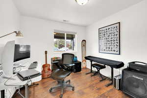 Office area with visible vents and wood finished floors