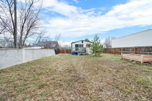 View of yard featuring a wooden deck and a fenced backyard