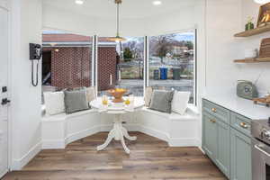 Unfurnished dining area with breakfast area, baseboards, wood finished floors, and recessed lighting