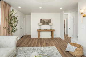 Foyer featuring recessed lighting, baseboards, a textured ceiling, and wood finished floors