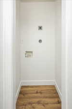 Washroom featuring baseboards, washer hookup, laundry area, wood finished floors, and hookup for an electric dryer