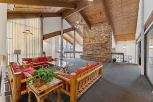 Carpeted living room with beamed ceiling, wood ceiling, high vaulted ceiling, and ceiling fan