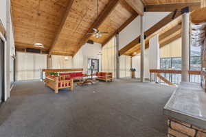 Rec room featuring a ceiling fan, carpet floors, high vaulted ceiling, beam ceiling, and wood ceiling