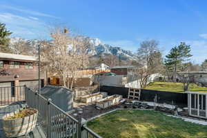 View of yard with a garden, a mountain view, and a fenced backyard