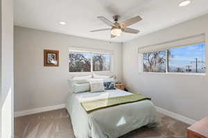 Carpeted bedroom with recessed lighting, baseboards, and a ceiling fan