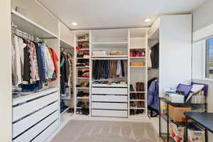 Spacious closet featuring carpet flooring