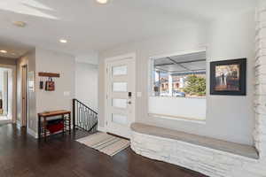 Foyer entrance featuring recessed lighting, dark wood-style floors, and baseboards