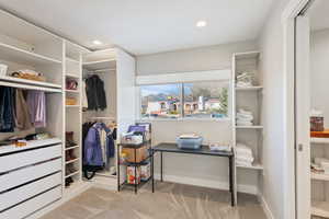 Spacious closet with carpet flooring