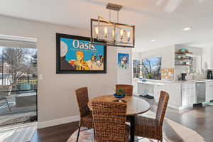 Dining room featuring recessed lighting, baseboards, a chandelier, and dark wood-style flooring