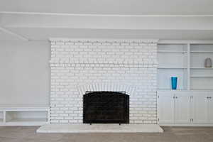 Interior details with a brick fireplace and carpet floors