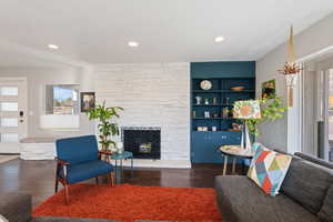 Living area featuring recessed lighting, wood finished floors, and a fireplace