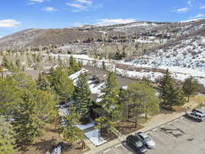 Snowy aerial view featuring a residential view and a mountain view