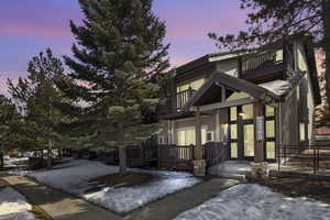 View of front of property with a balcony and a porch