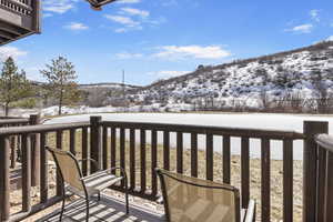 Snow covered back of property with a mountain view