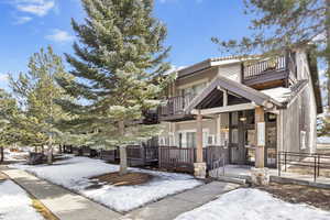 View of front of home featuring a porch and a balcony